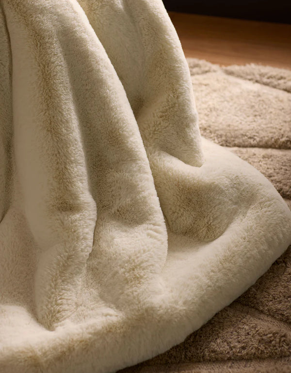 Faux fur throw blanket in cream