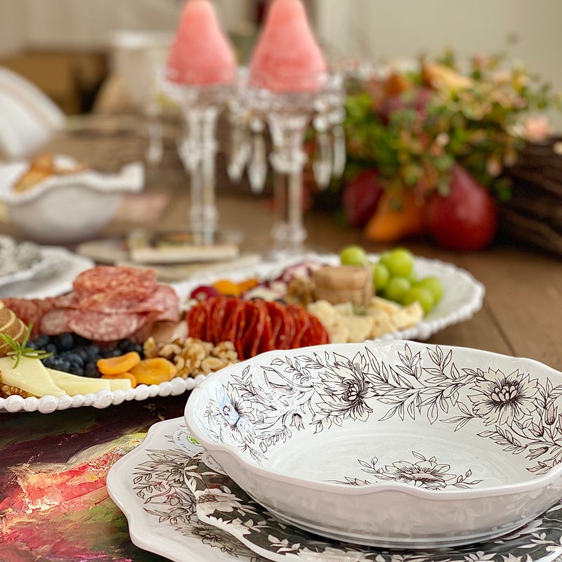 Elegant table setting with dinnerware, candles and white melamine charcuterie tray by Beatriz Ball.